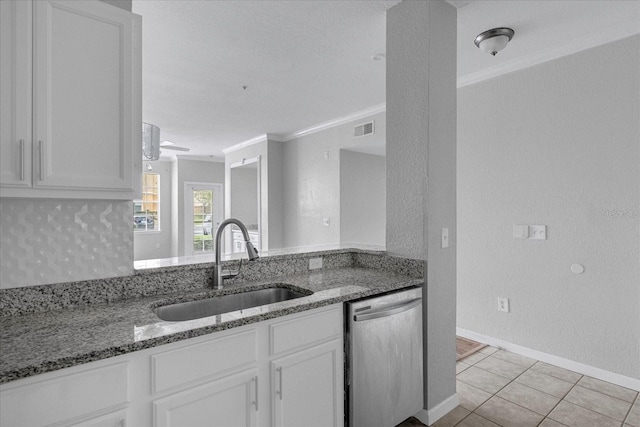 kitchen with dishwasher, sink, white cabinets, and stone countertops