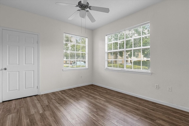 empty room with wood-type flooring and ceiling fan