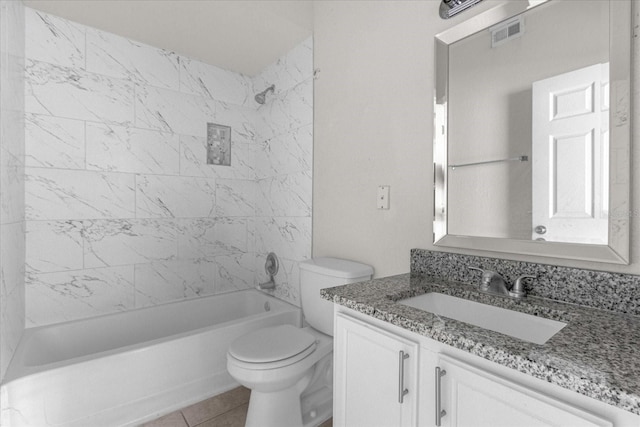 full bathroom featuring tile patterned floors, tiled shower / bath combo, toilet, and vanity