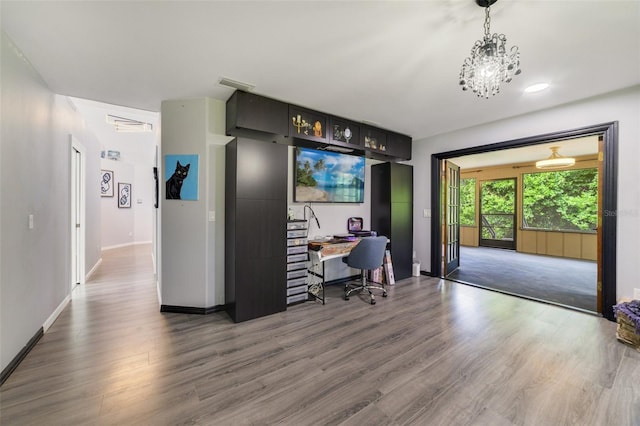 office area featuring dark wood-type flooring and an inviting chandelier