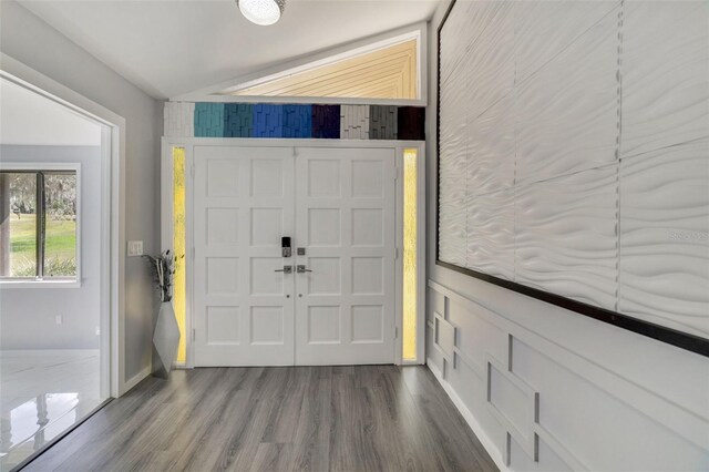 entrance foyer featuring hardwood / wood-style flooring and vaulted ceiling