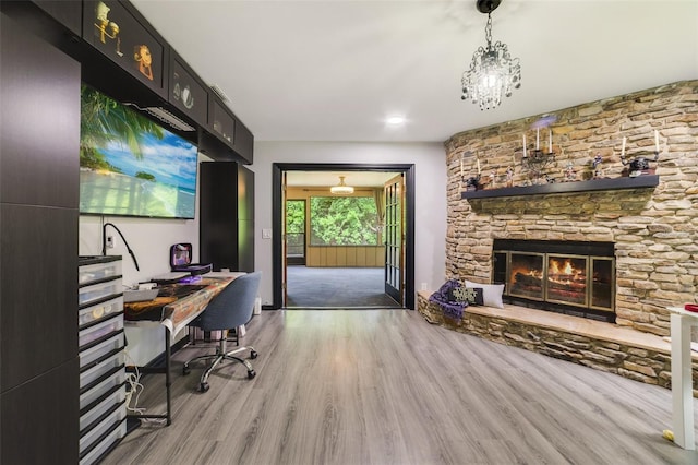 office space featuring light hardwood / wood-style flooring and a stone fireplace