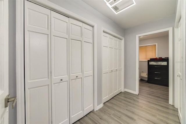 hallway with light hardwood / wood-style flooring