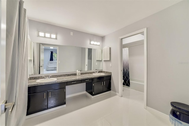 bathroom with tile patterned floors, shower / bath combo with shower curtain, and vanity