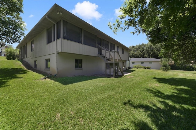 view of side of home featuring a yard and a sunroom