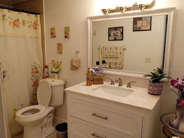 bathroom featuring toilet and vanity with extensive cabinet space