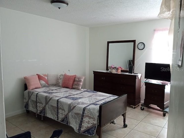 tiled bedroom with a textured ceiling