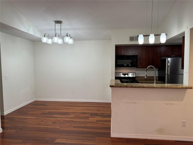 kitchen featuring stainless steel appliances, dark wood-type flooring, a sink, and dark brown cabinetry