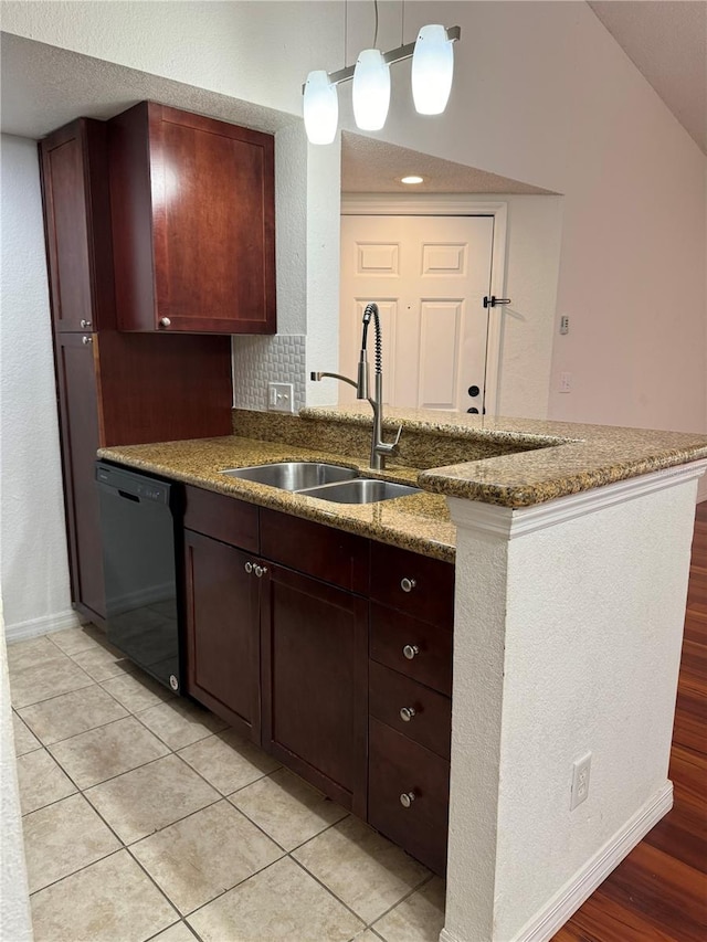 kitchen with a peninsula, a sink, light stone countertops, dishwasher, and decorative light fixtures