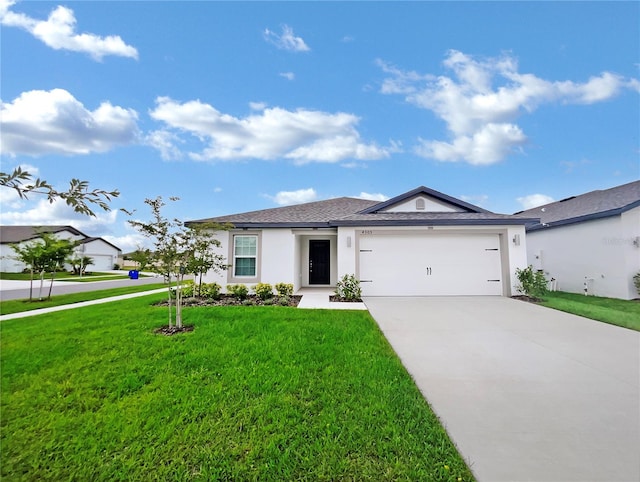 view of front of house with a front yard and a garage