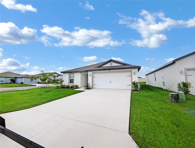 ranch-style house featuring a garage and a front lawn