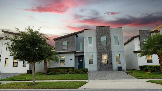 modern home featuring a yard