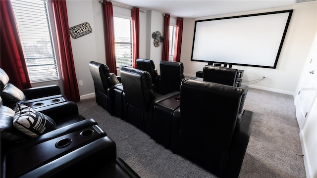 carpeted home theater featuring a healthy amount of sunlight