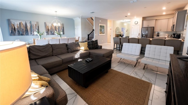 tiled living room with an inviting chandelier