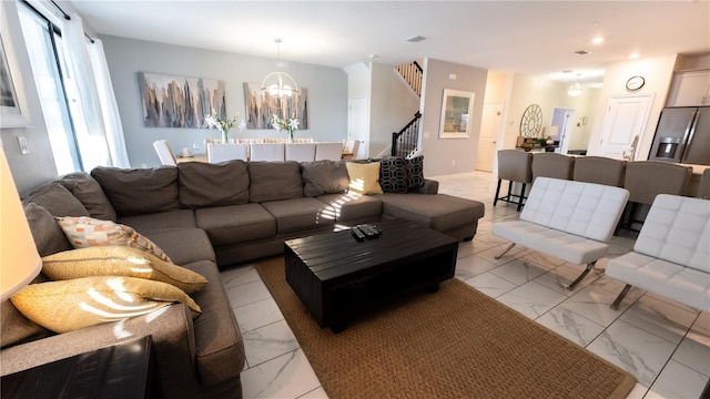 living room featuring light tile floors and an inviting chandelier