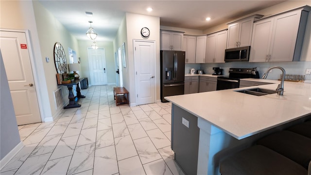 kitchen featuring black fridge with ice dispenser, decorative light fixtures, kitchen peninsula, range with electric stovetop, and gray cabinets