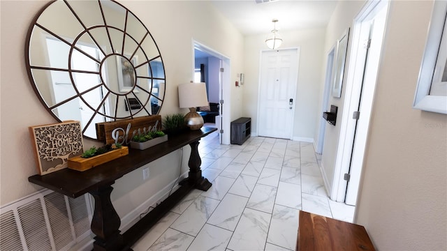 entryway with plenty of natural light and light tile flooring