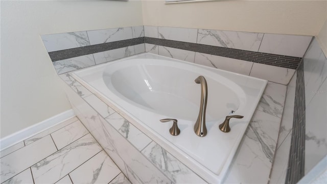 bathroom with a relaxing tiled bath and tile floors