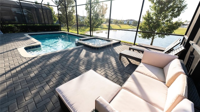 view of pool featuring a patio, a lanai, an in ground hot tub, and a water view