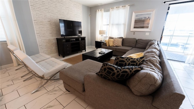 living room with brick wall and tile floors