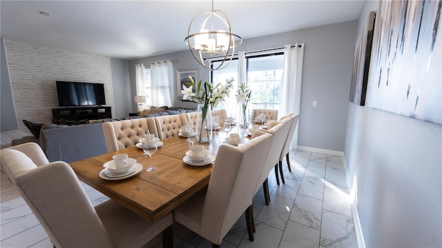 tiled dining room with a chandelier