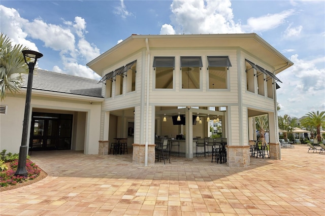 back of house with a patio area and exterior bar