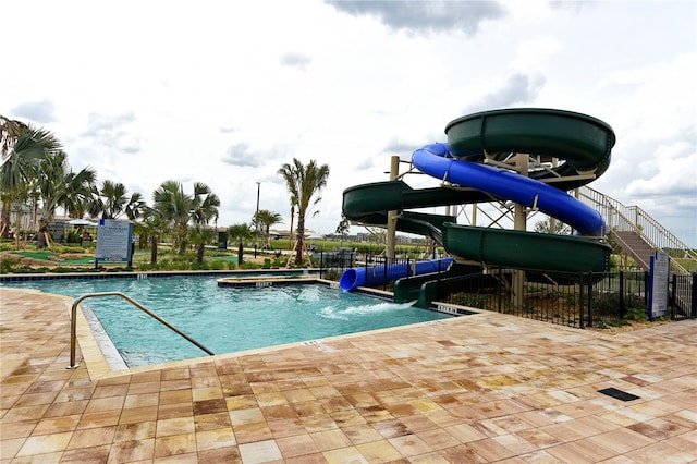 view of pool featuring a water slide and a patio area