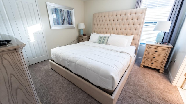 bedroom with dark colored carpet