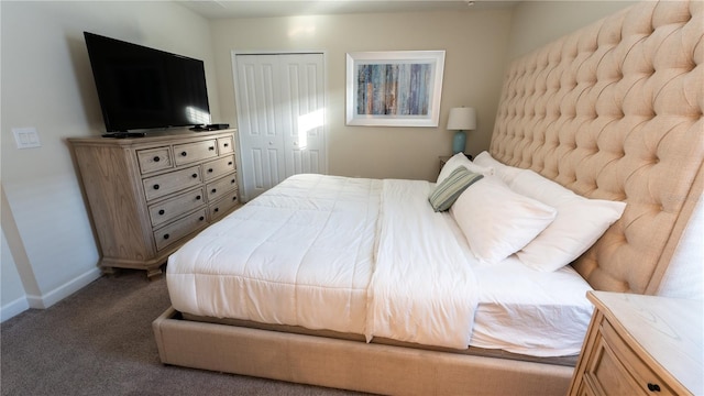 bedroom featuring a closet and dark carpet