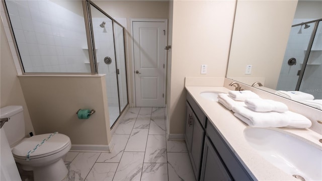 bathroom featuring a shower with door, tile flooring, dual bowl vanity, and toilet