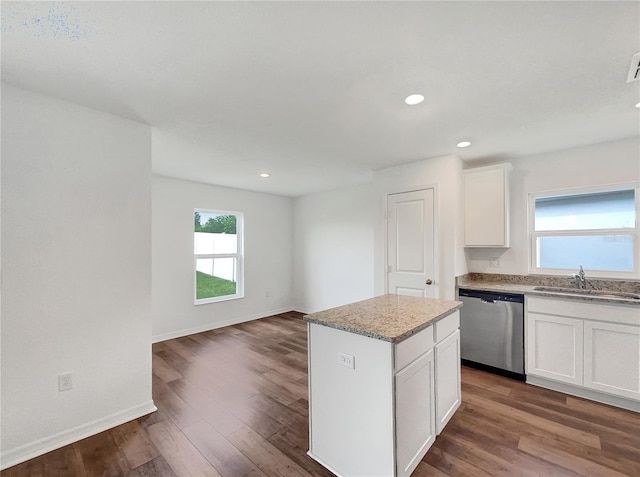 kitchen with a center island, dark hardwood / wood-style flooring, white cabinetry, sink, and stainless steel dishwasher