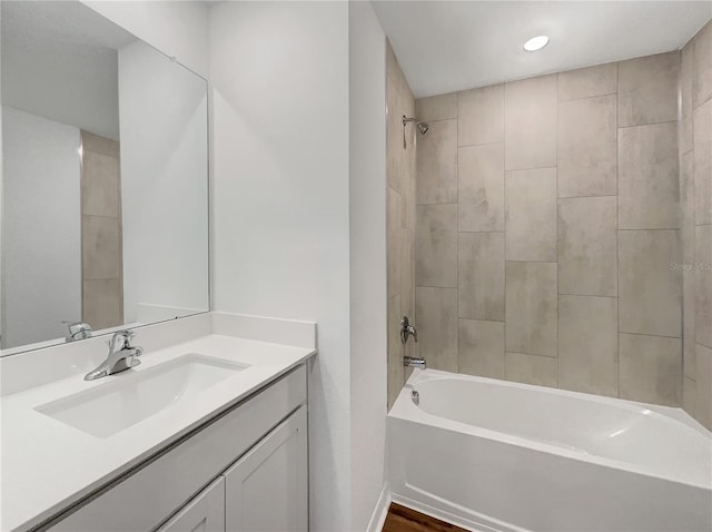 bathroom featuring vanity and tiled shower / bath