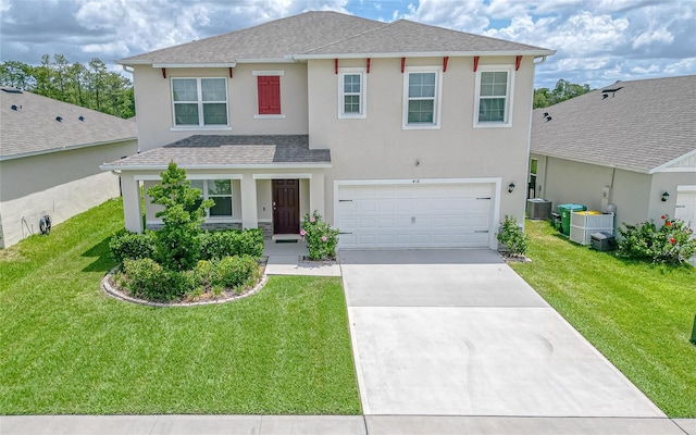 view of front of property with a garage, a front lawn, and central AC unit