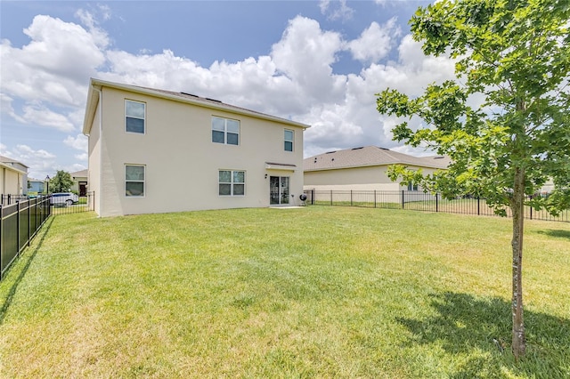 back of house featuring a yard