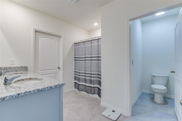 bathroom with toilet, tile flooring, and double sink vanity