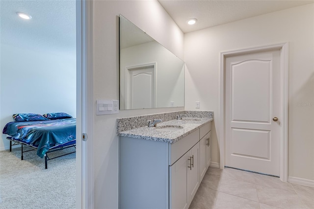 bathroom featuring vanity with extensive cabinet space and tile flooring