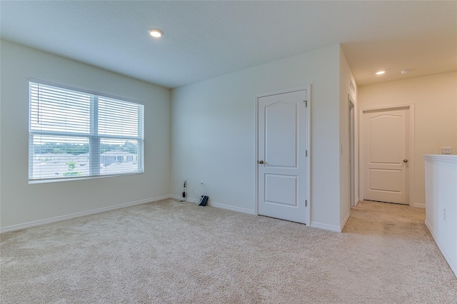 spare room with light colored carpet