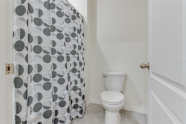 bathroom with tile floors and toilet