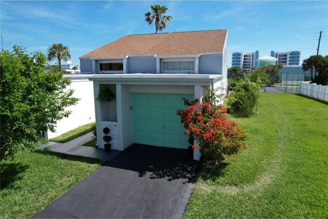 view of front of home with a garage and a front lawn