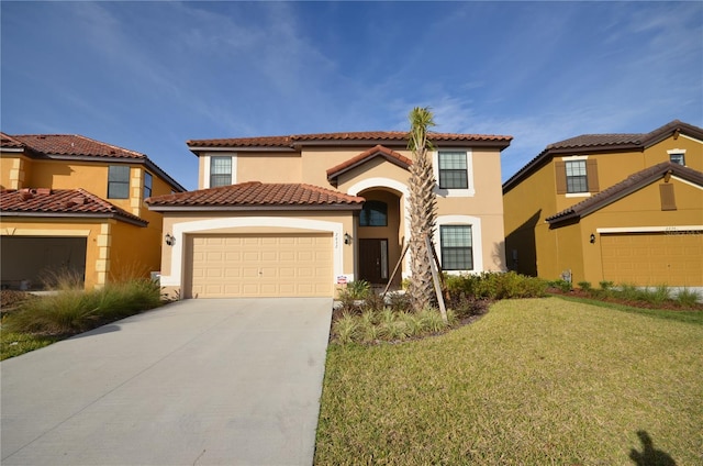 mediterranean / spanish house with a garage and a front yard