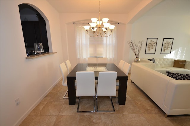 tiled dining area featuring a chandelier