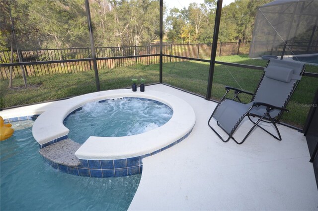 view of swimming pool featuring a lanai, a yard, an in ground hot tub, and a patio area