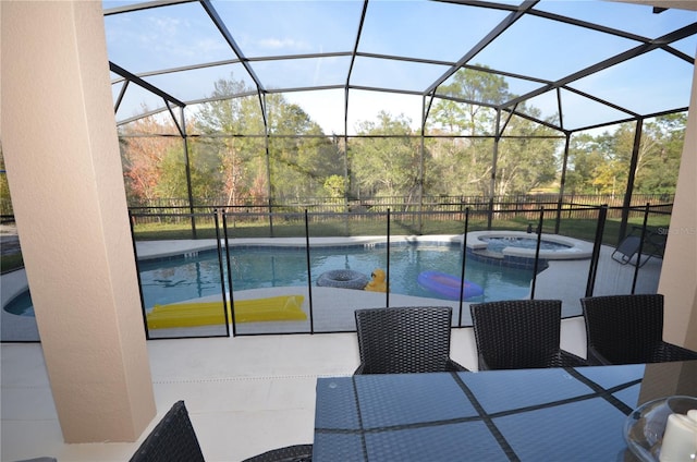 view of swimming pool featuring a lanai, an in ground hot tub, and a patio area