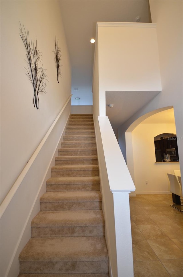 stairs featuring tile flooring