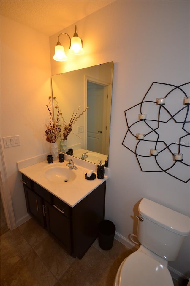 bathroom featuring tile flooring, toilet, and large vanity