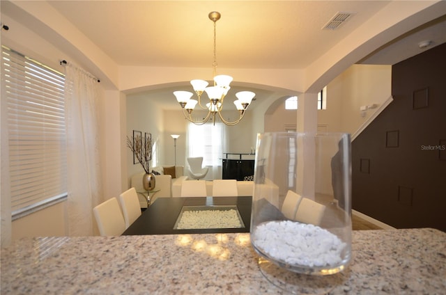 dining space featuring a notable chandelier