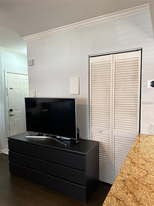 interior space with hardwood / wood-style floors and ornamental molding