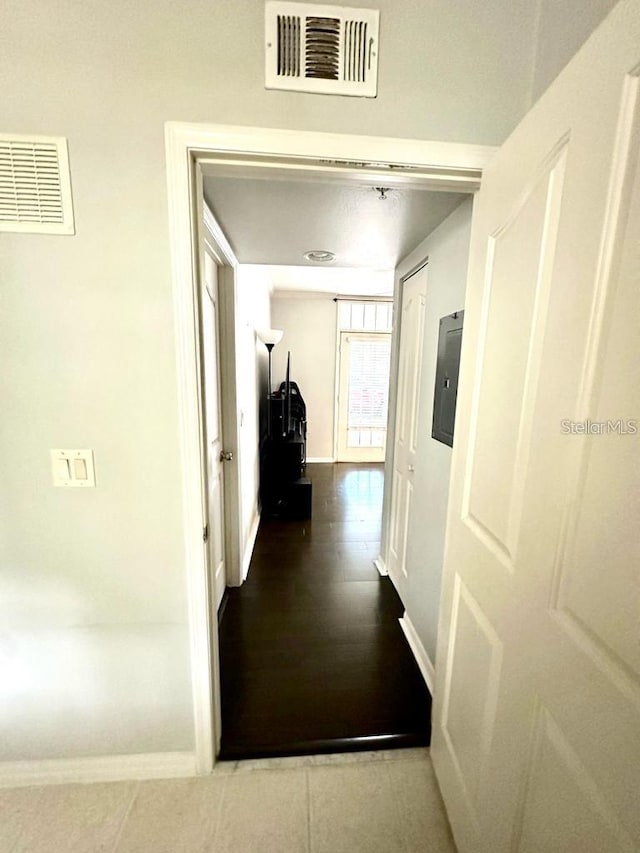 corridor with electric panel and hardwood / wood-style flooring