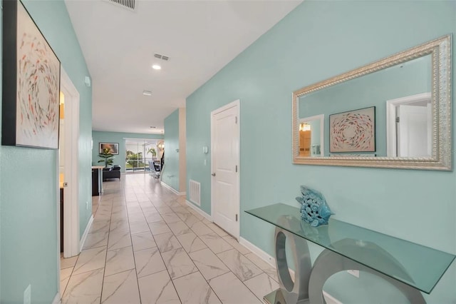 hallway featuring light tile floors