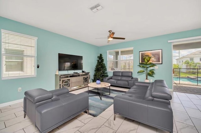 living room featuring ceiling fan and light tile floors